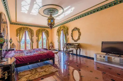 a bedroom with a bed and a flat screen tv at Quinta do Galvao - Luxury Villa by HD PROPERTIES in Quarteira