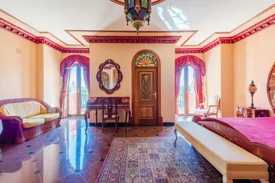 a room with a bed and a table and a mirror at Quinta do Galvao - Luxury Villa by HD PROPERTIES in Quarteira