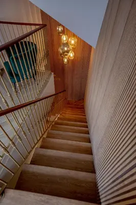 a staircase in a building with a chandelier at Guest House Jacarandá Faro in Faro