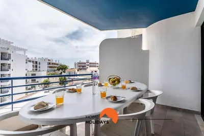a white table with food and drinks on a balcony at #169 T3 Medronheira by Home Holidays in Albufeira