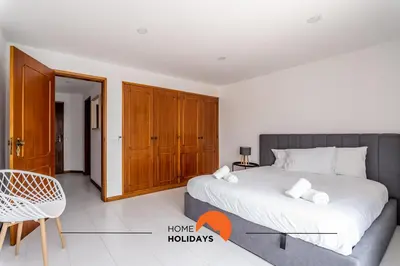 a bedroom with a bed and a table and a chair at #169 T3 Medronheira by Home Holidays in Albufeira