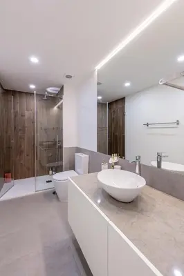 a bathroom with a sink and a tub and a toilet at Compromisso 25 in Faro