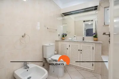 a bathroom with a white toilet and a sink at #174 T2 em Zona Tranquila by Home Holidays in Albufeira