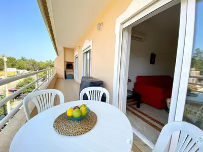a table with a bowl of fruit on a balcony at Vilamoura Typical 2 With Pool by Homing in Vilamoura