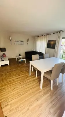 a living room with a white table and a couch at Charming triplex T2 in the Old Village Vilamoura in Quarteira