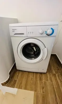 a washer and dryer sitting in a room at Charming triplex T2 in the Old Village Vilamoura in Quarteira