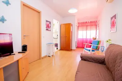 a living room with a couch and a television at Casinha VII by Innkeeper in Guia