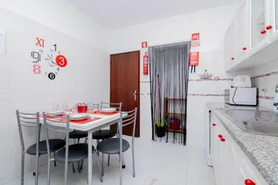 a kitchen with a table and chairs in a room at Casinha VII by Innkeeper in Guia