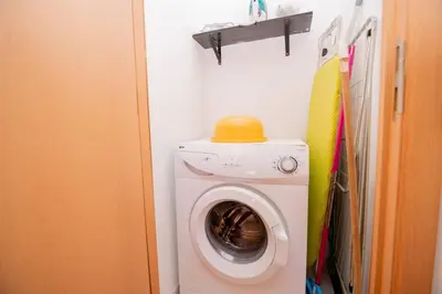 a washing machine with a yellow ball on top of it at Casinha VII by Innkeeper in Guia