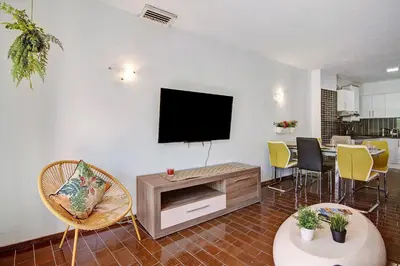 a living room with a flat screen tv on a wall at Hanna's Sunny Apartment in Albufeira