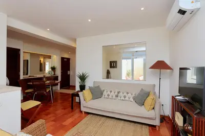 a living room with a white couch and a dining room at Marina Vista Sol-CleverDetails, Marina view, sleeps 2 adults and 2 children in Vilamoura