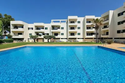 a large swimming pool in front of a building at Sea Beside in Albufeira