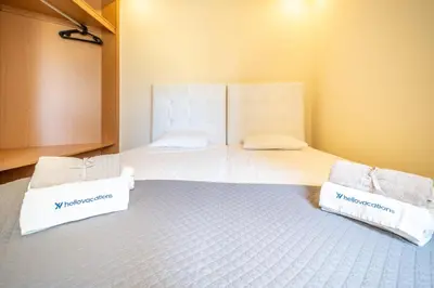 a bedroom with two beds with towels on them at Mourabel Apartment - S by HelloVacations in Loulé