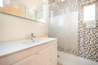 a bathroom with a sink and a shower at Mourabel Apartment - S by HelloVacations in Loulé