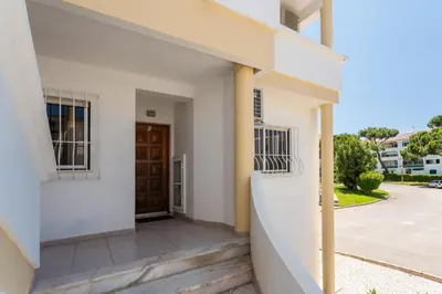 a view from the outside of a building with a door at Host Wise - Amazing Sunny Flat - Swimming Pool & Terrace in Vilamoura