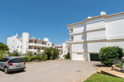 a car parked in a parking lot in front of a building at Host Wise - Amazing Sunny Flat - Swimming Pool & Terrace in Vilamoura