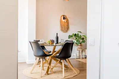 a white kitchen with white cabinets and a microwave at Villa Amour Charming Duplex Apartment on Marina in Quarteira
