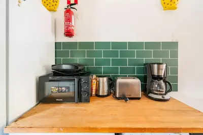 a kitchen counter with a microwave and a toaster oven at Sunny Villa with golf front view in Vilamoura