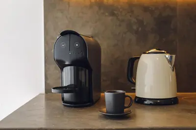 a coffee maker and a coffee pot on a counter at CASA AMOR JACARANDA - Ocean View Modern Vila in Albufeira