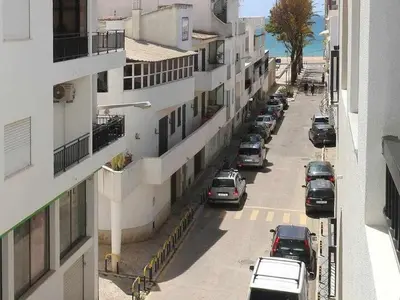 a group of cars parked in a parking lot next to buildings at Mar á vista by FHR 2 minutos á praia in Quarteira