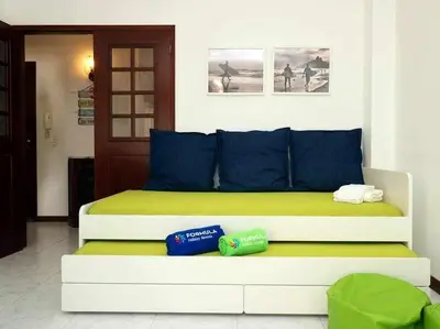 a bedroom with a large bed with blue pillows at Mar á vista by FHR 2 minutos á praia in Quarteira