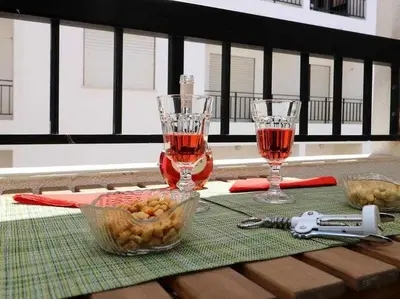 a table with two wine glasses and a bowl of food at Mar á vista by FHR 2 minutos á praia in Quarteira