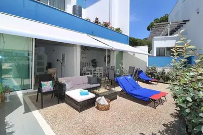 a patio with a couch and chairs and a table at Anzol By FHR in Quarteira