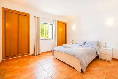 a bedroom with a bed and a window at Villa Arrifes by Atlantic Places in Albufeira