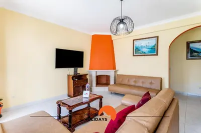 a living room with a couch and a tv at #180 T2 Ondas do Mar by Home Holidays in Albufeira