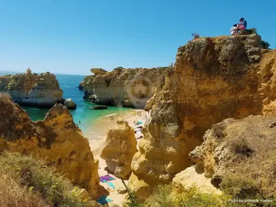 a group of people on a beach near the ocean at Studio Camélia 67 at São Rafael Beach - Albufeira in Albufeira