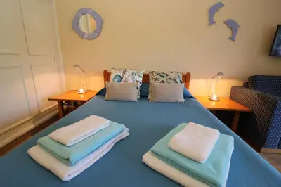 a blue bed with towels on top of it at Studio Camélia 67 at São Rafael Beach - Albufeira in Albufeira