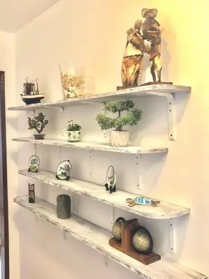 a white shelf with plants and figurines on it at Casa do Limoeiro in Albufeira