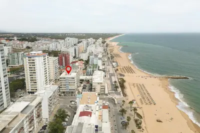 an aerial view of a beach with buildings and the ocean at Horizonte - Sea view by HD PROPERTIES in Quarteira