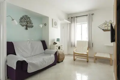 a living room with a bed and a chair at Horizonte - Sea view by HD PROPERTIES in Quarteira