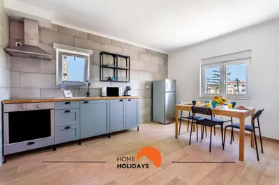 a kitchen with a table and a dining room at #179 Monte das Churras 2 by Home Holidays in Albufeira