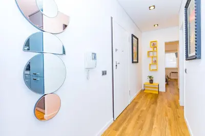 a hallway with circular shelves on the wall at Stunning Exclusive Parque Atlântico in Quarteira