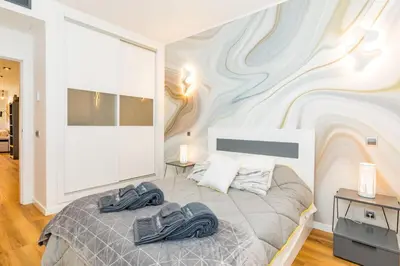 a bedroom with a bed with two slippers on it at Stunning Exclusive Parque Atlântico in Quarteira