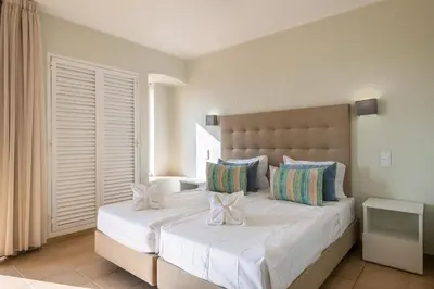 a bedroom with a large bed with white sheets and pillows at Albufeira Jardim Studio with Sea View - Free Wi-Fi - Pool in Albufeira