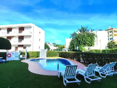 a couple of chairs and a swimming pool at Vilamoura Twins 2 With Pool by Homing in Vilamoura