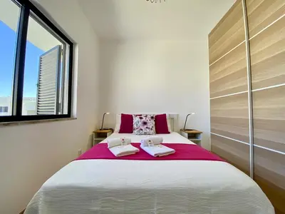 a bedroom with a large bed with two towels on it at Vilamoura Twins 2 With Pool by Homing in Vilamoura