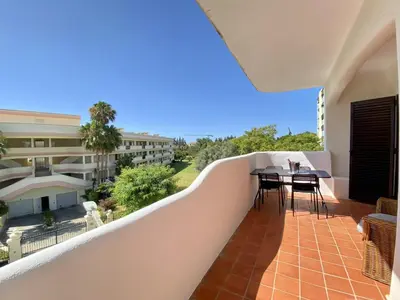 a balcony with a table and chairs on it at Vilamoura Twins 2 With Pool by Homing in Vilamoura