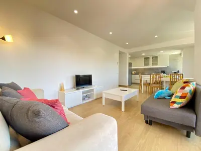 a living room with a couch and a table at Vilamoura Twins 2 With Pool by Homing in Vilamoura