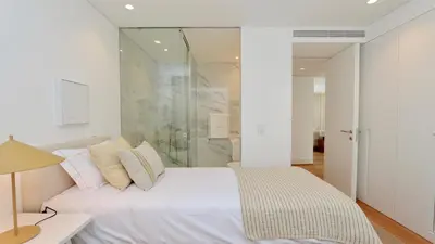 a bedroom with a white bed and a glass shower at Lake24 CD256- CleverDetails, 3 bedroom apartment, sleeps 6, near to Falesia Beach and the Marina in Vilamoura