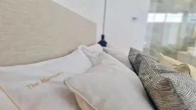 a group of pillows on a bed with a window at Lake24 CD256- CleverDetails, 3 bedroom apartment, sleeps 6, near to Falesia Beach and the Marina in Vilamoura