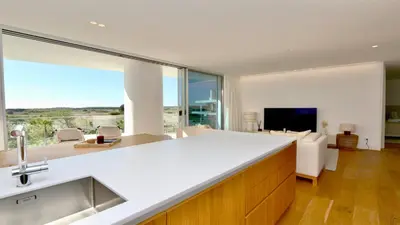 a kitchen with a view of a living room at Lake24 CD256- CleverDetails, 3 bedroom apartment, sleeps 6, near to Falesia Beach and the Marina in Vilamoura
