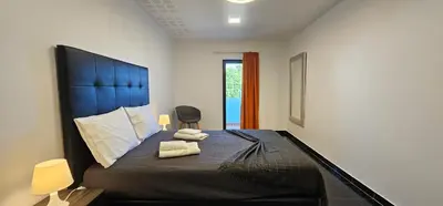 a bedroom with a bed with two towels on it at Original Apartments in Albufeira