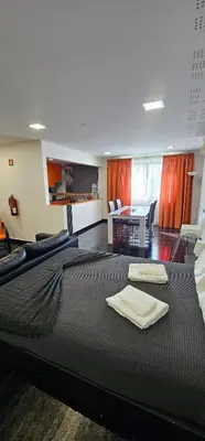 a bedroom with a large bed with two towels on it at Original Apartments in Albufeira