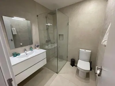 a bathroom with a toilet and a sink and a shower at Praia Village AG in Vilamoura