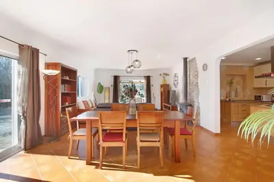 a kitchen and dining room with a table and chairs at Casa Palma in Paderne