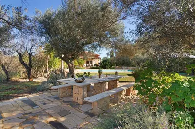 a stone table and bench in a garden at Casa Palma in Paderne